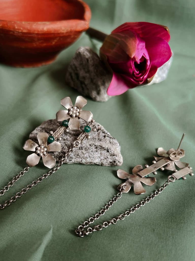 Prakruti silver earring with flower motif and emerald stone