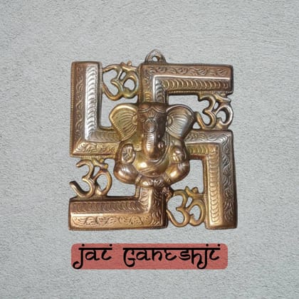 Ganeshji back swastik & om God idol Metal murti on the wall.