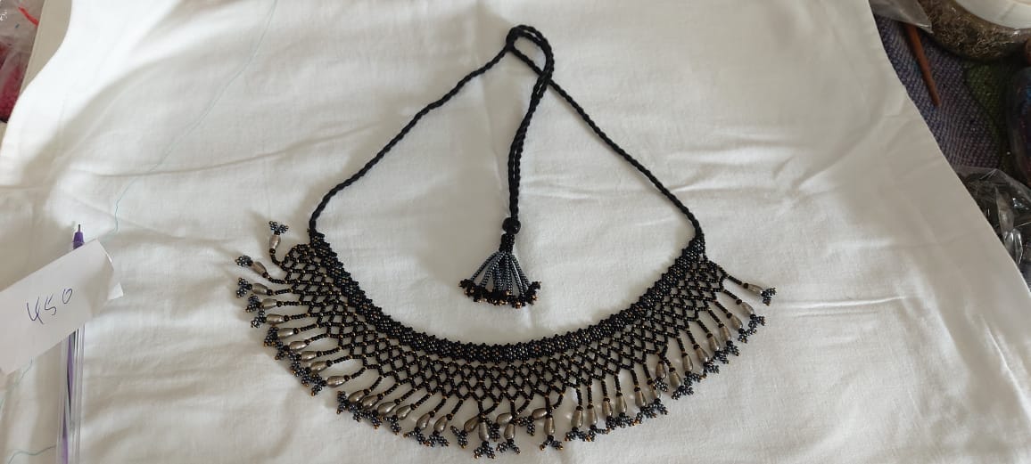 Black and White Necklace With a Striking Combination of Beads and Tassels