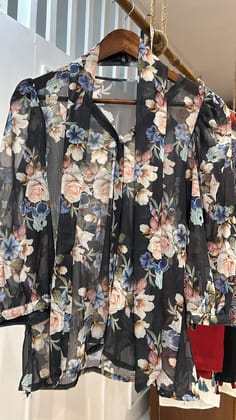 Semi-sheer black top with a flowy design Top