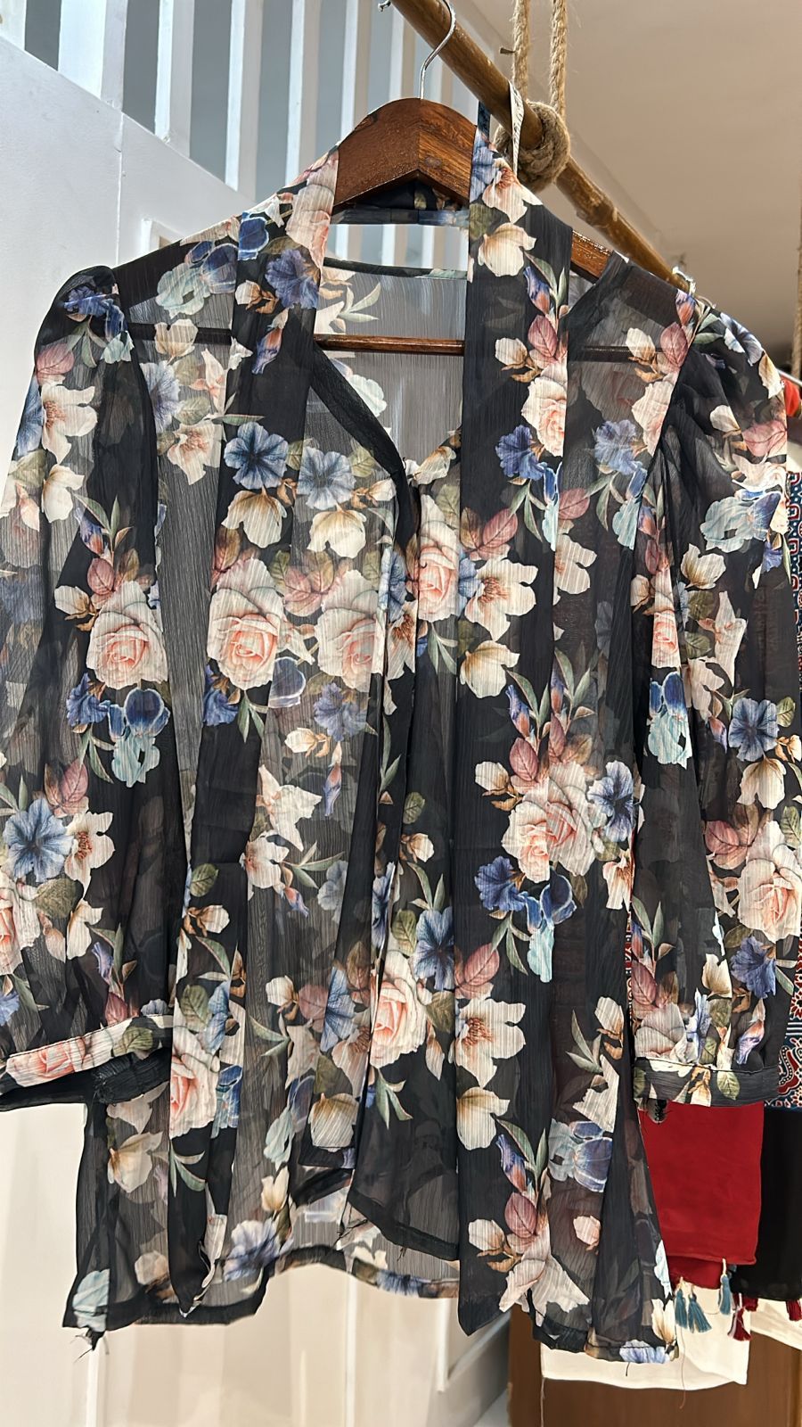 Semi-sheer black top with a flowy design Top