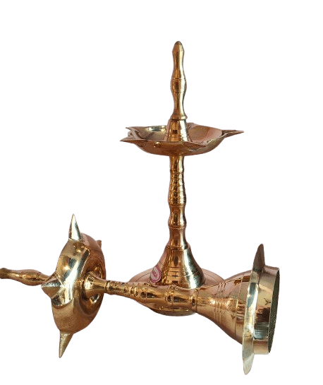 A pair of brass oil lamps with a traditional design