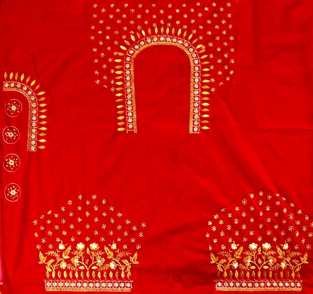 Red and gold embroidered blouse with intricate floral and leaf motifs, featuring a deep U-shaped neckline and pearl and sequin embellishments.