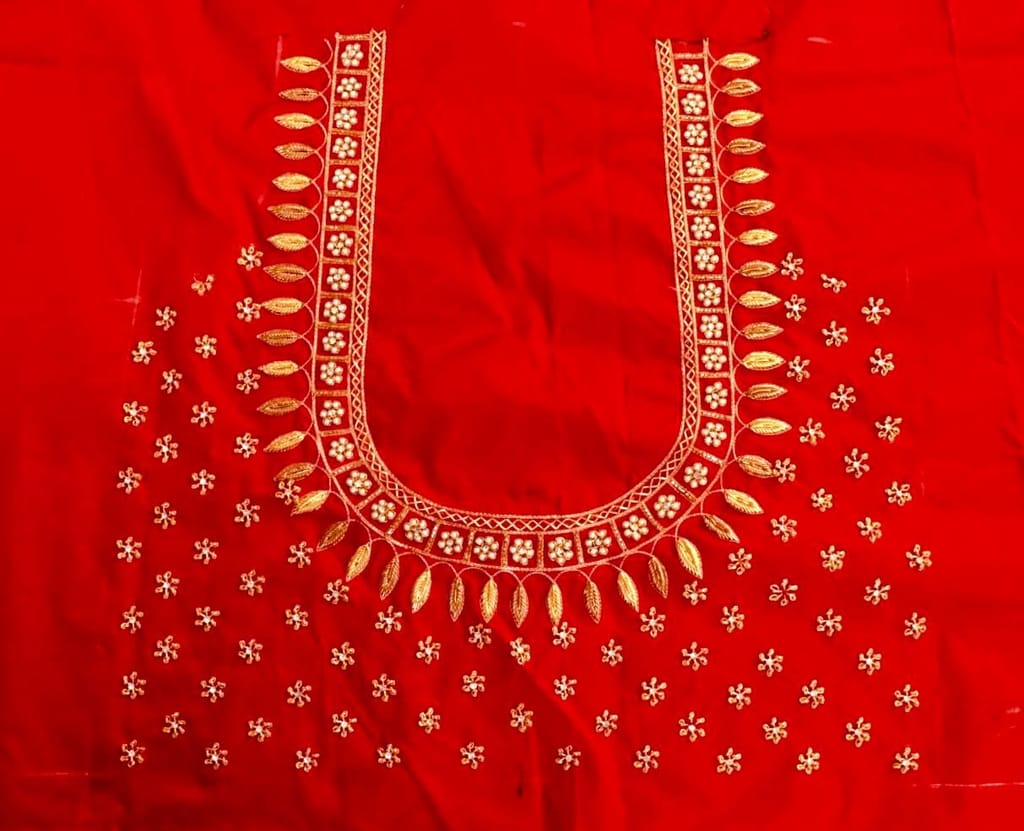 Red and gold embroidered blouse with intricate floral and leaf motifs, featuring a deep U-shaped neckline and pearl and sequin embellishments.