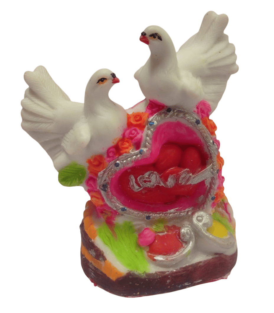 A beautiful showpiece of two white doves perched on a heart-shaped base