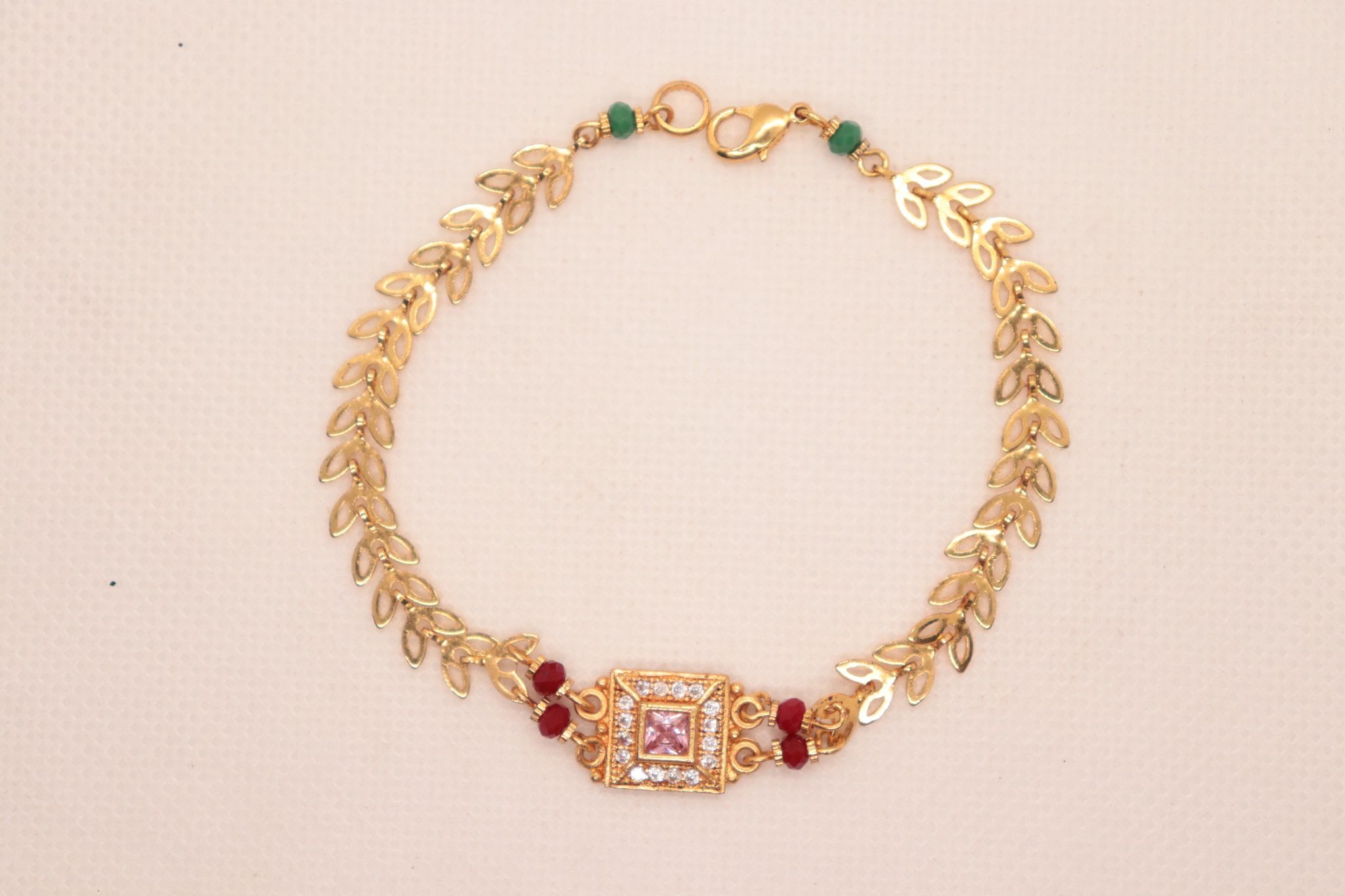 Bracelet with Center Square Pink Stone Surrounded by Clear Stones and Red Stones