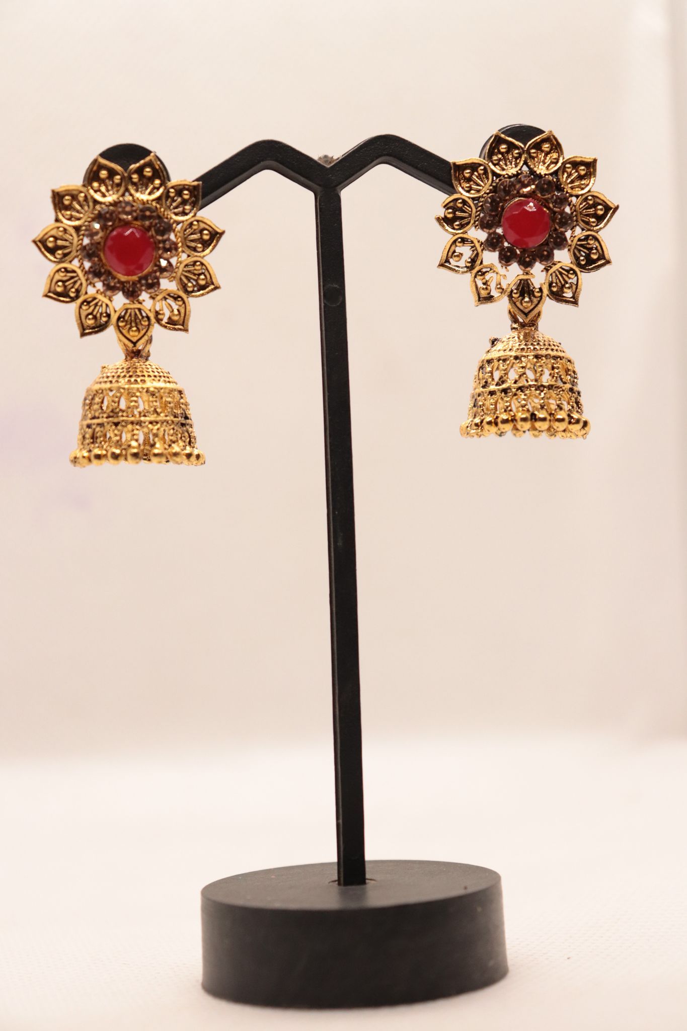 "Stunning Red Stone Jhumka Earrings with Intricate Gold Design"