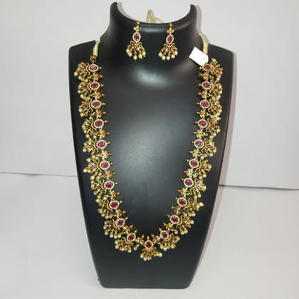 Gold-plated traditional long haram necklace set with ruby and emerald stones and matching earrings for women