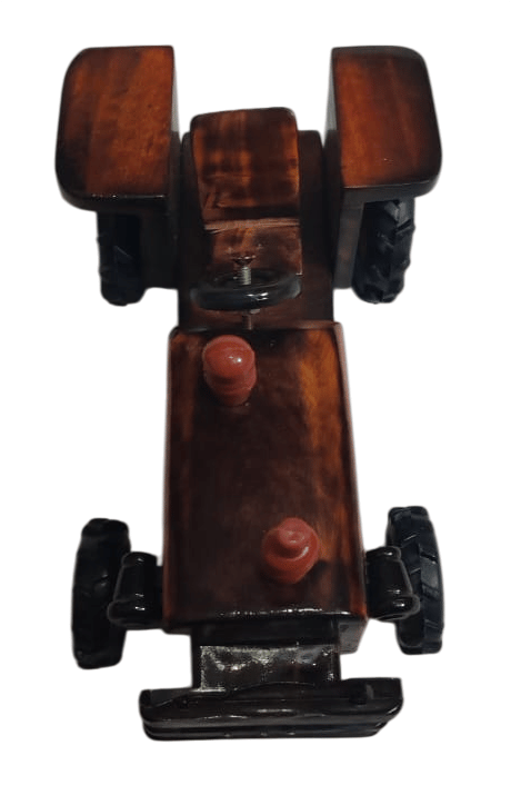Wooden toy tractor handcrafted from a single piece of wood. Perfect for children