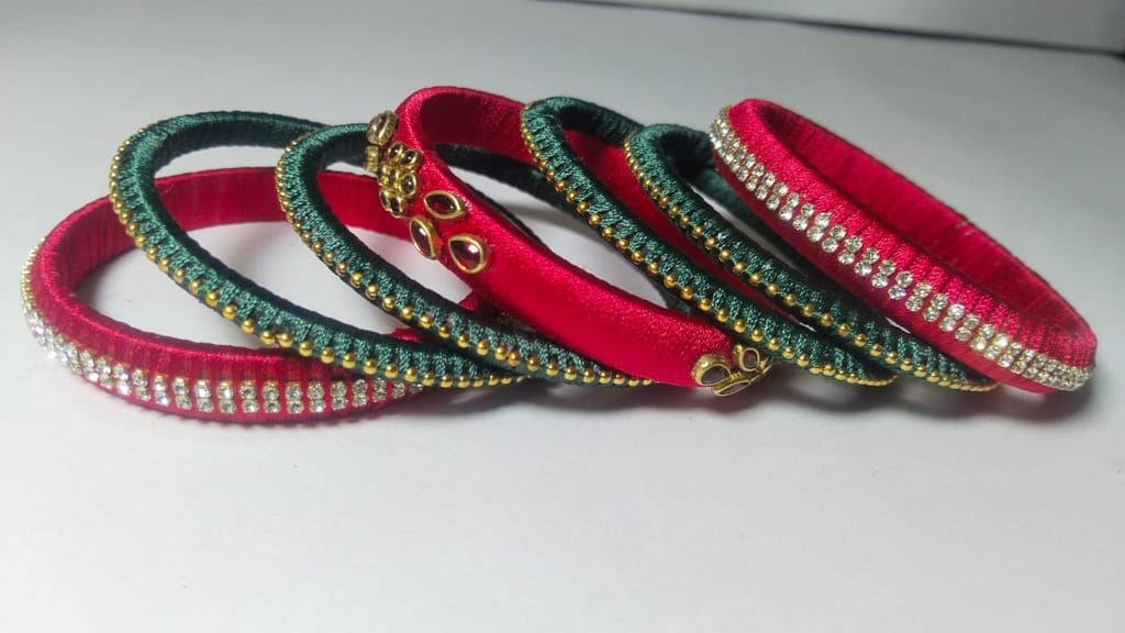 Red and green silk thread bangles with stone and pearl embellishment