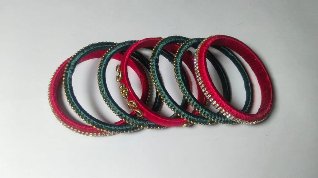Red and green silk thread bangles with stone and pearl embellishment