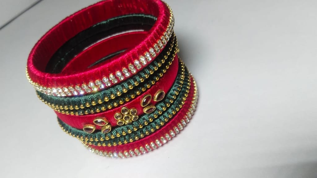 Red and green silk thread bangles with stone and pearl embellishment
