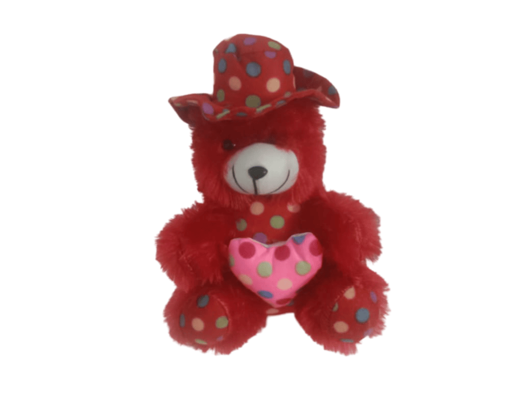 Red polka dot teddy bear wearing a colorful hat and holding a pink heart