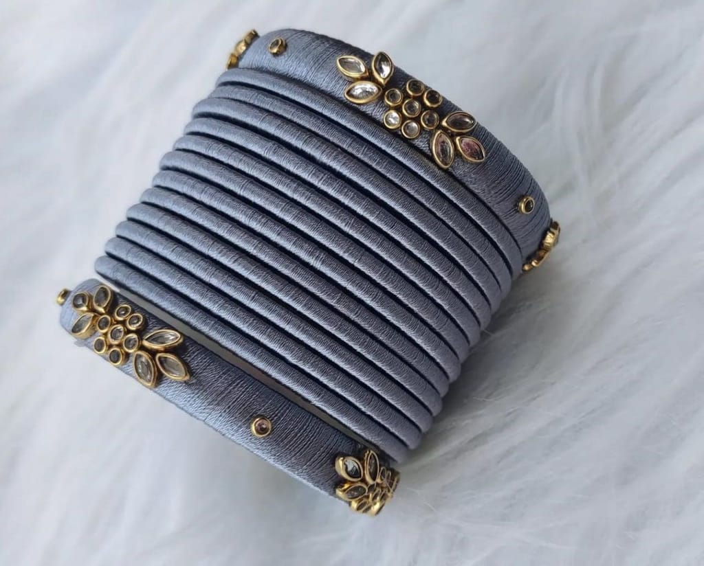 oxidised finish grey silk thread bangles with golden floral design