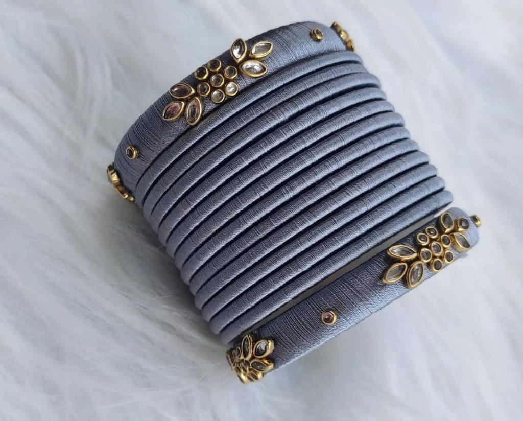 oxidised finish grey silk thread bangles with golden floral design