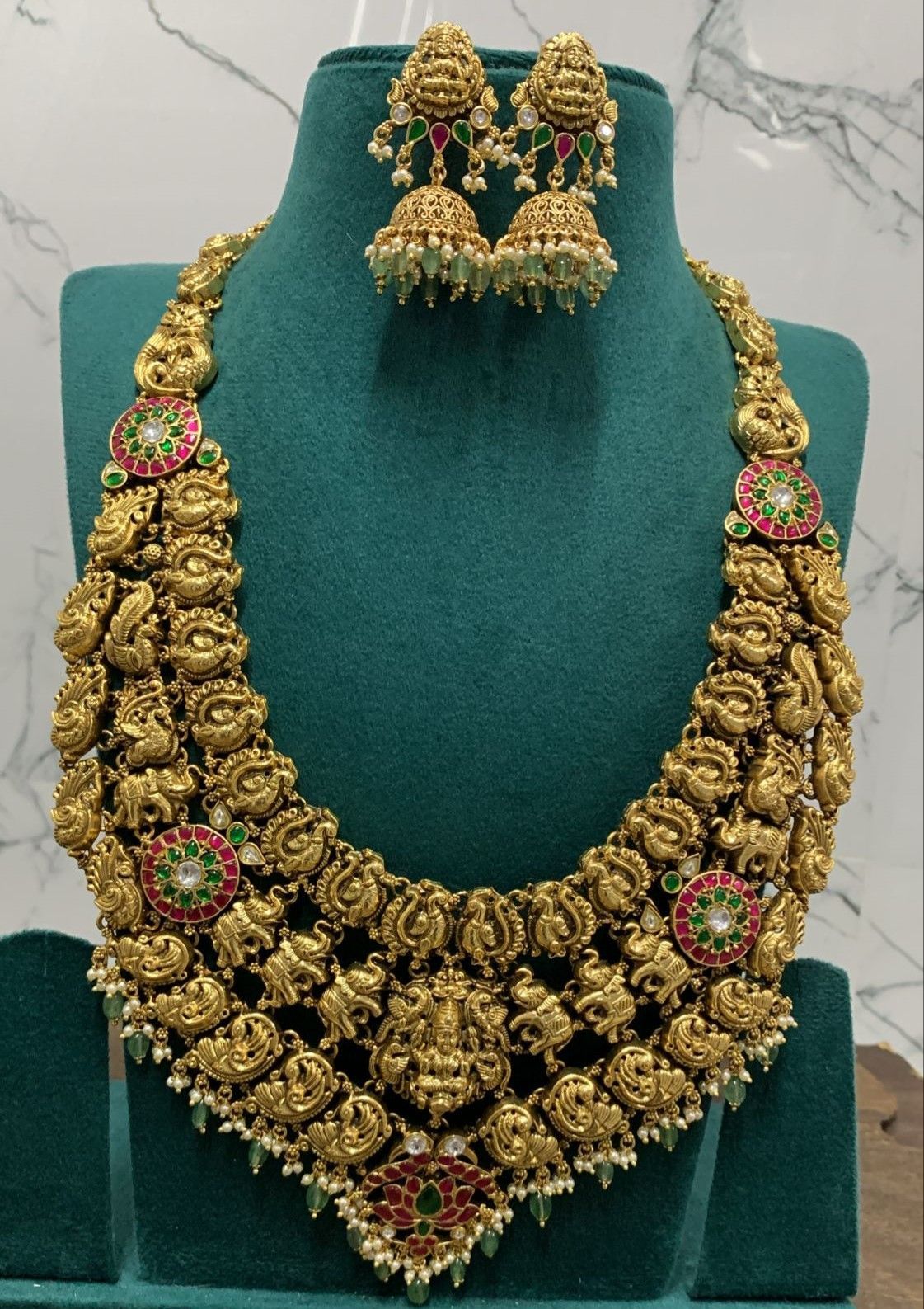 Exquisite antique gold haram necklace set with intricate carvings and gemstones