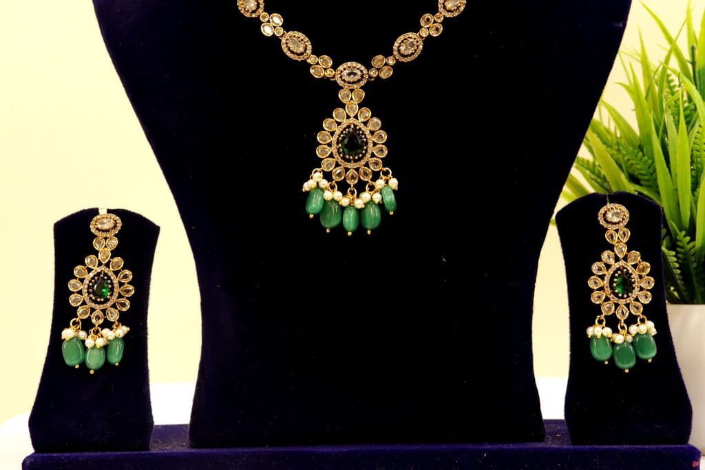 Gold-plated Kundan and Pearl Necklace Set with Green Stones