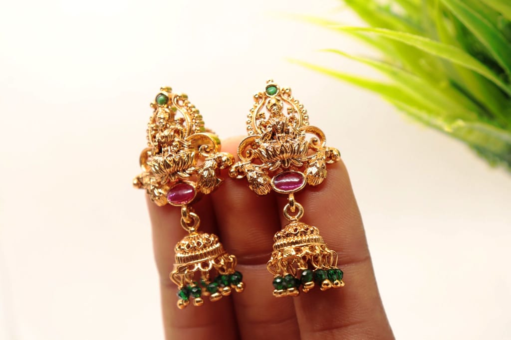 Gold Plated Goddess Lakshmi Antique Jhumka Earrings With Green Stones