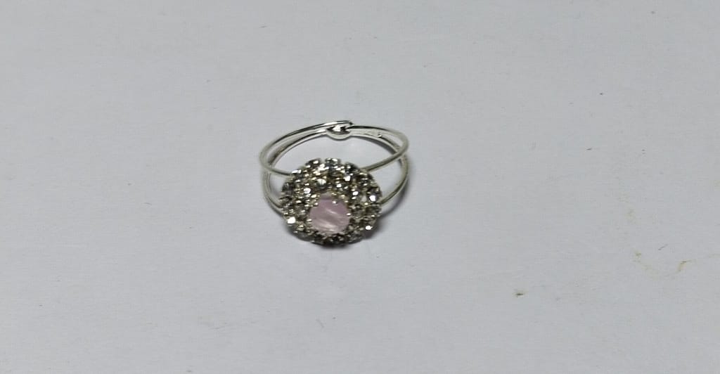 "Elegant Silver-Plated Ring with Pink Center Stone and Rhinestone Accents"