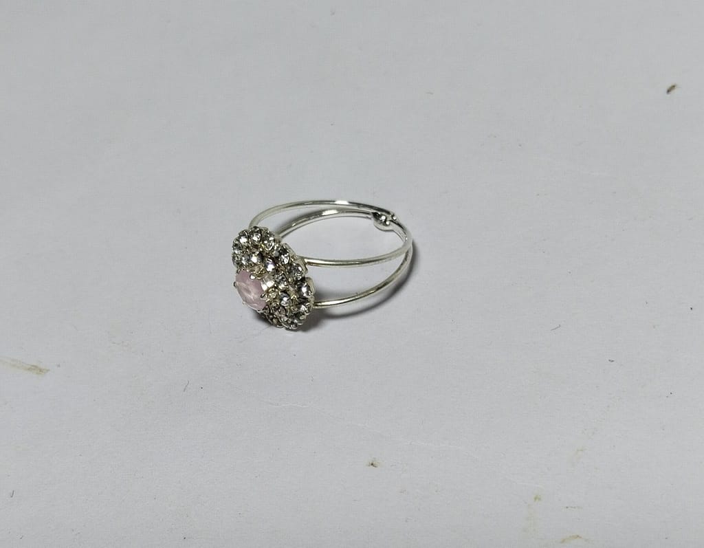 "Elegant Silver-Plated Ring with Pink Center Stone and Rhinestone Accents"