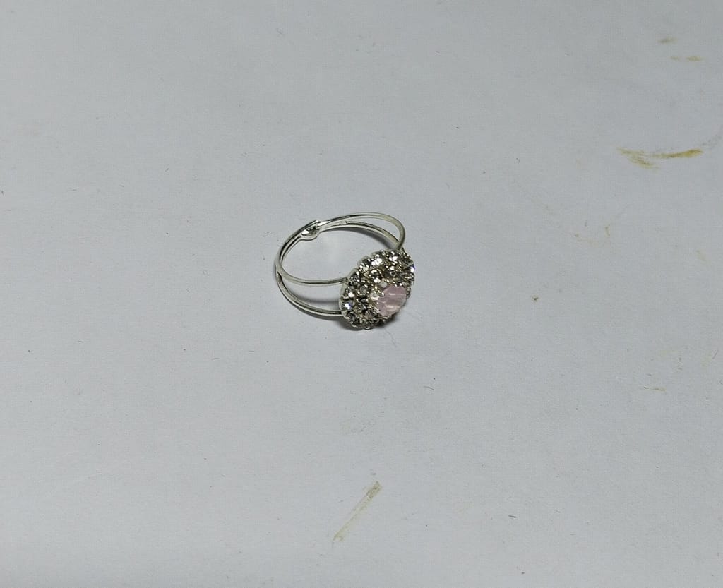 "Elegant Silver-Plated Ring with Pink Center Stone and Rhinestone Accents"