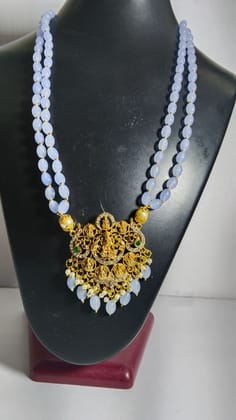 "Stunning and elegant pearl necklace with intricate gold pendant"