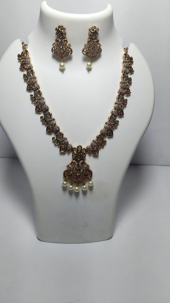Stunning antique gold plated traditional necklace set with intricate detailing and pearl drops