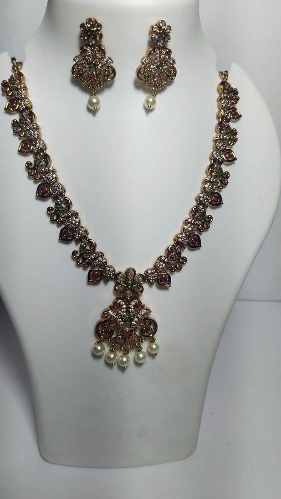 Stunning antique gold plated traditional necklace set with intricate detailing and pearl drops