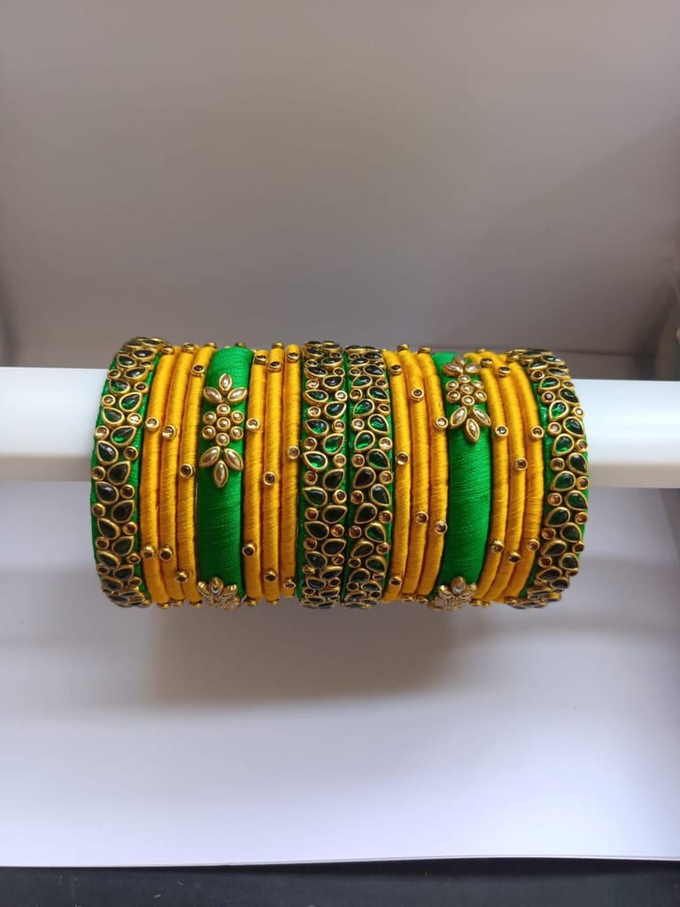 Green and gold silk thread bangles with kundan stones