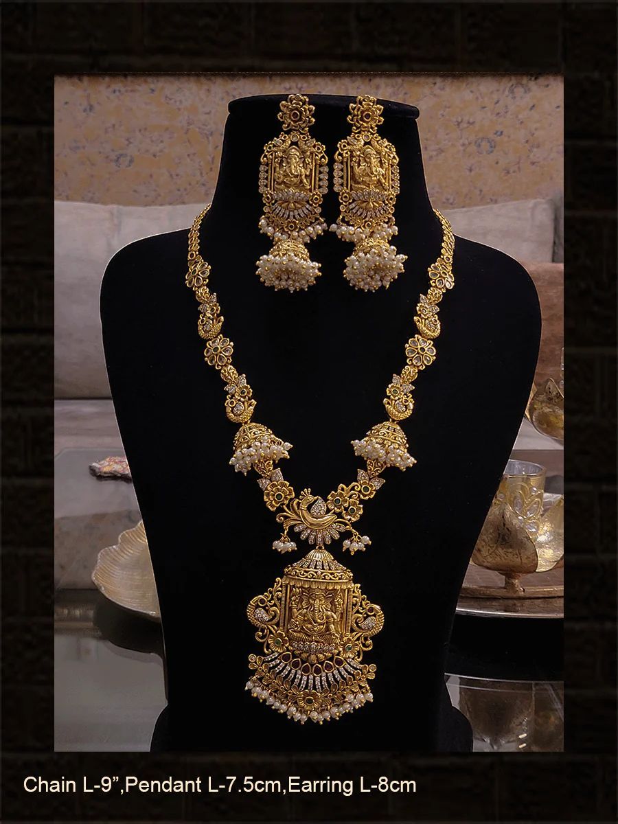 Polki,ruby,green and white stones studded ganpatiji pendant set with flowers and peacocks design