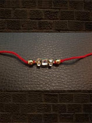 Kundan rakhi with gold bead in red and green thread-Red thread