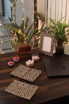 Gift Box with Work Desk Essential : 1 Diary, 1 Notepad, 1 Photoframe, 2 laddoo candles, 2 handblock candles-1 Diary, 1 Notepad, 1 Frame, 4 Candles