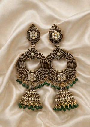 Vardaan Crystalx premium traditional Indian jhumka earrings with a striking antique bronze-gold finish, adorned with shimmering iridescent AB rhinestones and rich emerald-green bead cascades. Vardaan Crystalx premium traditional Indian jhumka earrings with a striking antique bronze-gold finish, adorned with shimmering iridescent AB rhinestones and rich emerald-green bead cascades.