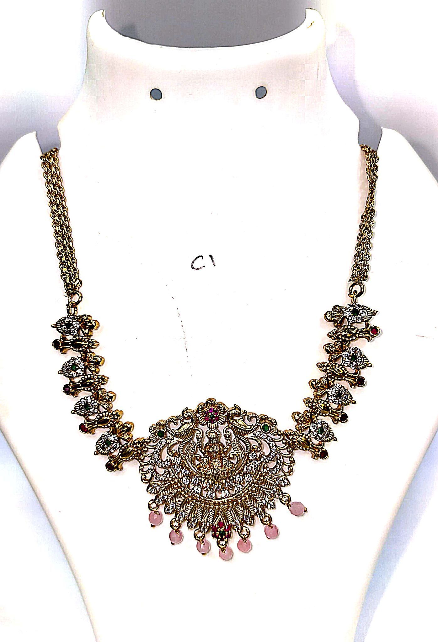 "Stunning antique gold necklace with intricate detailing and colorful gemstones."
