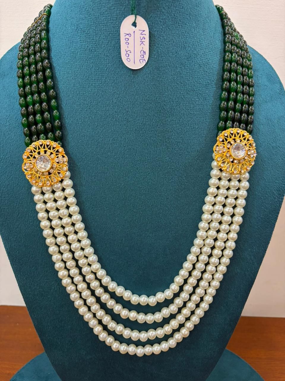 four-layer green and white moti pearl neckalce with gold round brooches