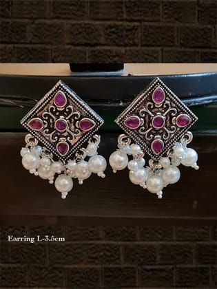 Kite shaped stone studded german silver earrings with pearl drops-Ruby