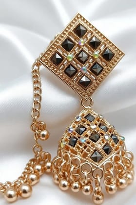 Vardaan Crystalx Earing with chain is a elegant gold-tone jhumka earring with side chain, featuring black stone detailing and delicate ghunghru drops  perfect for every women in every traditional and festive season.