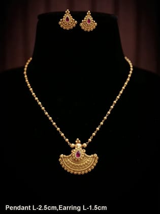 Traditional design tear drop ruby stone pendant set in gold bead chain