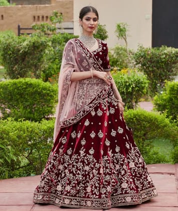 Red colored designer partywear embroidered work velvet material lehenga choli dc 202