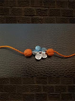 Sterling silver flower rakhi with orange thread