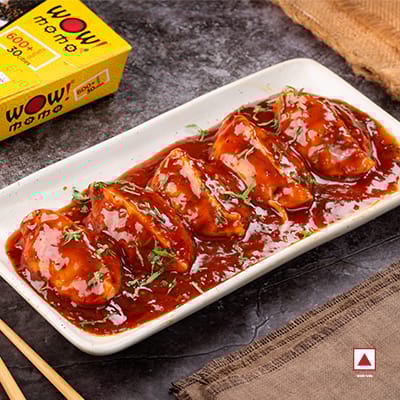 Chicken Delight Pan Fried Momo In Schezwan Sauce (Spicy)