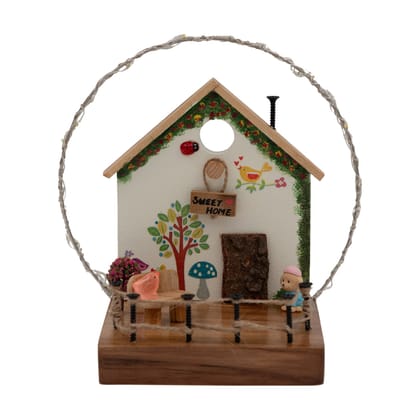 White Cottage with Bark Door & String Lights