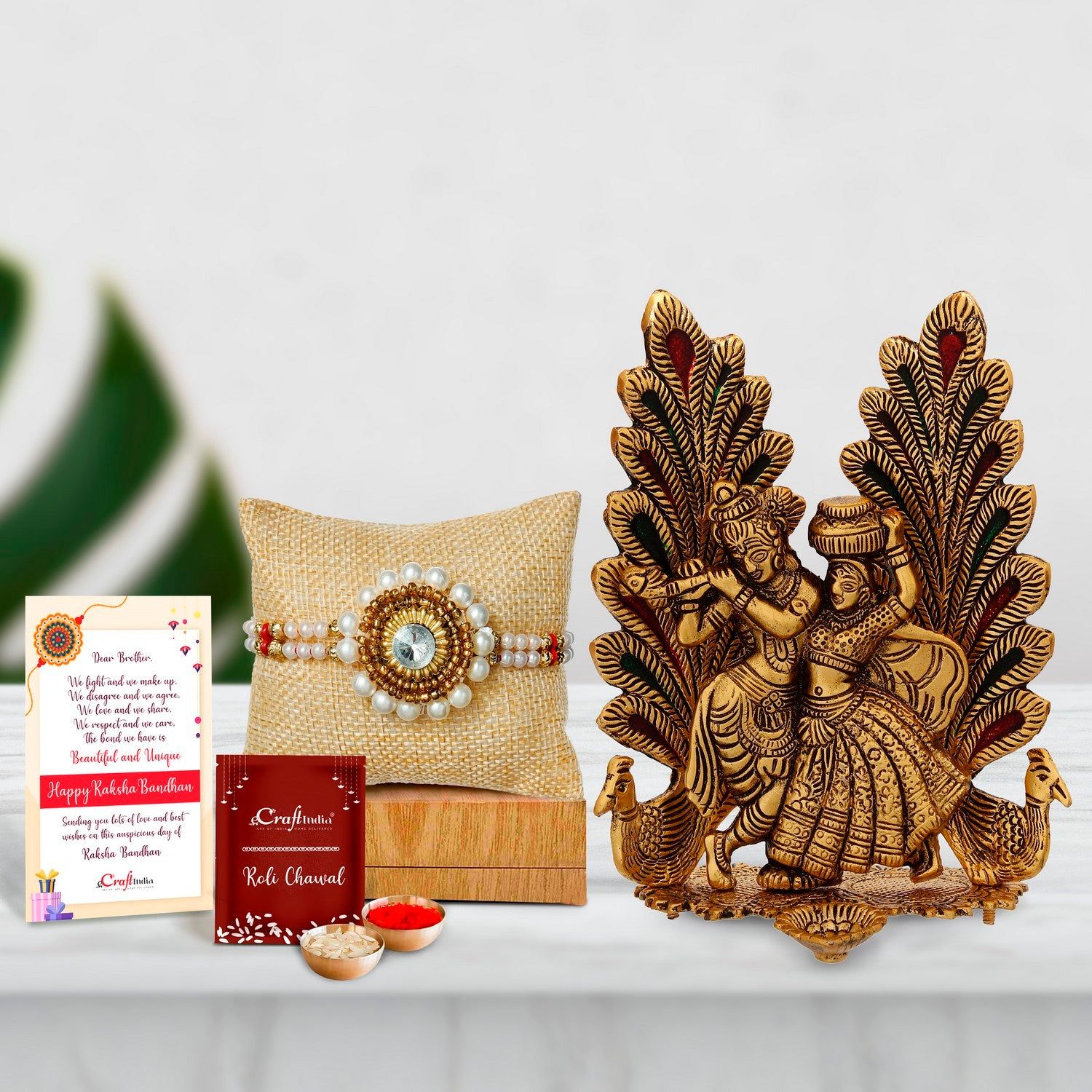 Designer Handcrafted Stone Pearl Rakhi with Golden Radha Krishna Idol Metal Decorative Showpiece with Diya and Roli Chawal Pack, Best Wishes Greeting Card