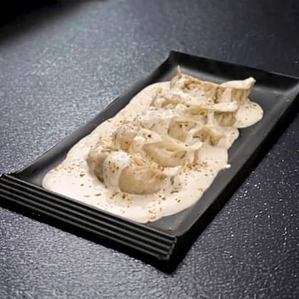 Chicken Wheat Momos In Molten Cheese Sauce