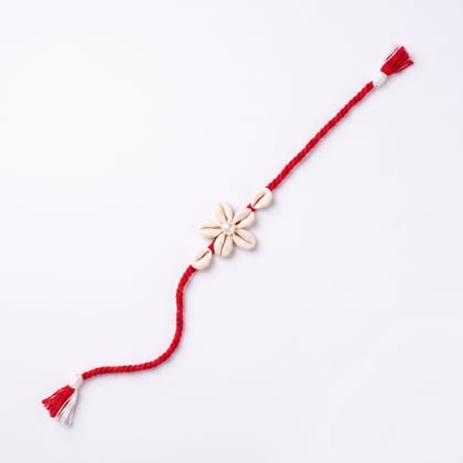 HANDMADE MACRAME RAKHI โ RED THREAD WITH FLORAL CHARM HANDMADE MACRAME RAKHI โ RED THREAD WITH FLORAL CHARM