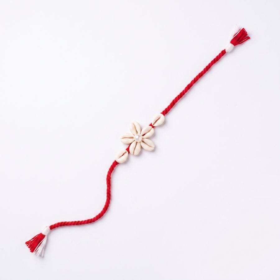 HANDMADE MACRAME RAKHI – RED THREAD WITH FLORAL CHARM