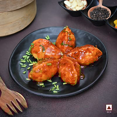Chicken Pahari Feast Pan Fried Momo In Schezwan Sauce (Spicy)