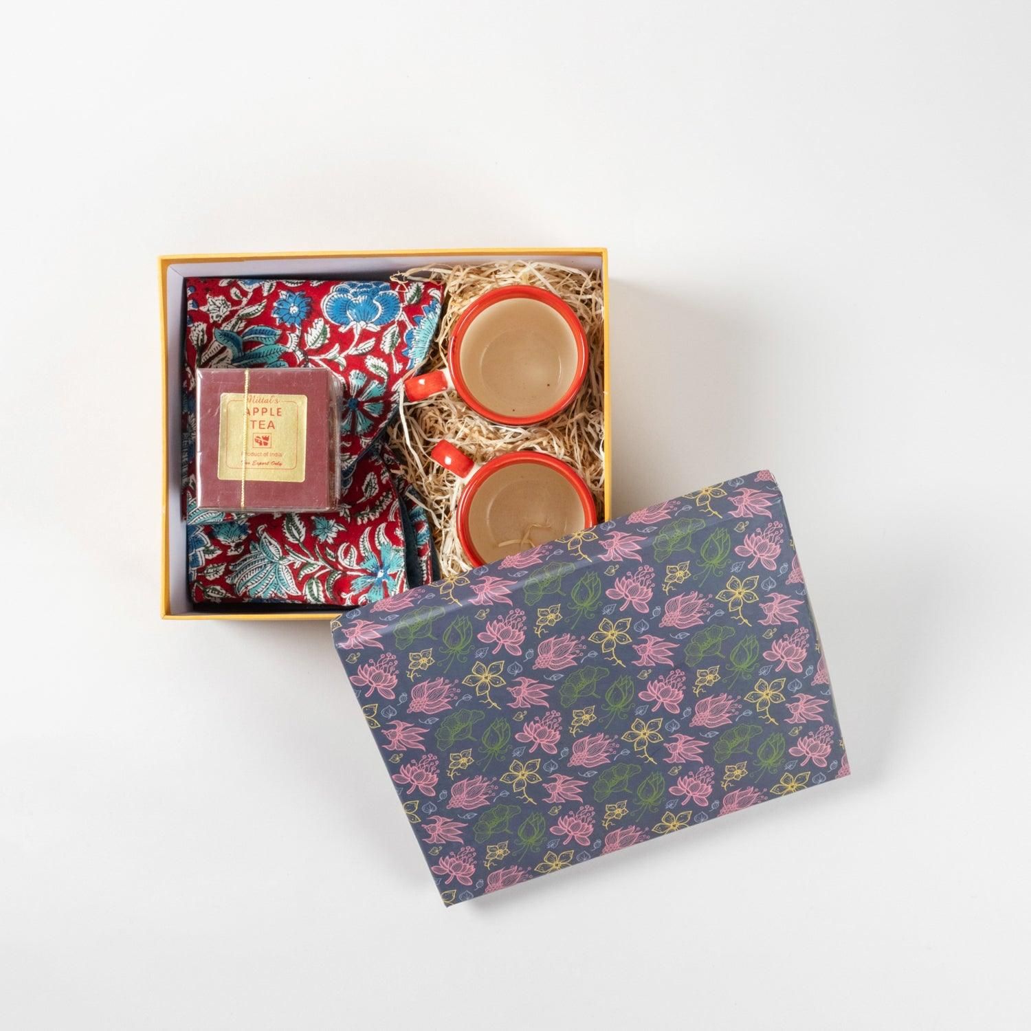 Gift Hamper of Tea Cups, Table Mats & A Box of Tea-Hand-painted Ceramic Cups x 2 / Table mats x 2 / Tea (100 gms) x 1. / 10 inches x 9 inches x 5.5 inches (Box Dimensions)