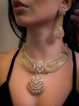 Multiple gold chains set with long moissanite pendant and tukdies on sides