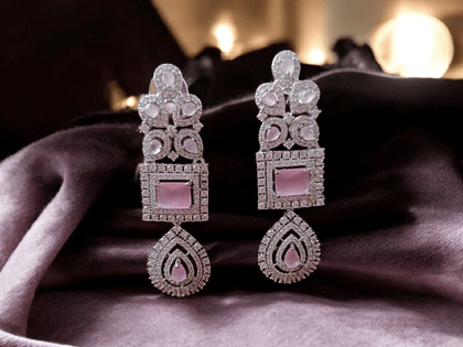  Crafted in 925 sterling silver, these earrings feature a square-shaped pink stone surrounded by a halo of shimmering cubic zirconia. The earrings are secured with a push back closure.